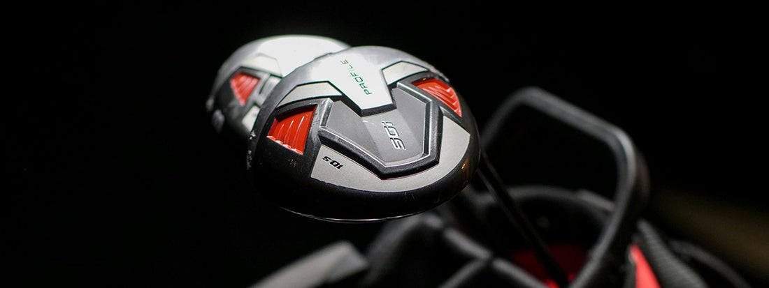 Close-up of golf club heads with a dark background