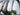 Close-up of golf club heads with different degrees of loft on a blurred background