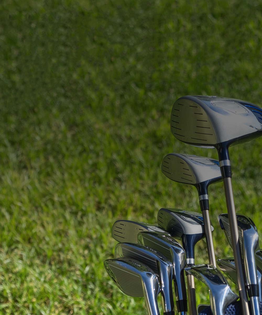 Set of golf clubs on a grassy background