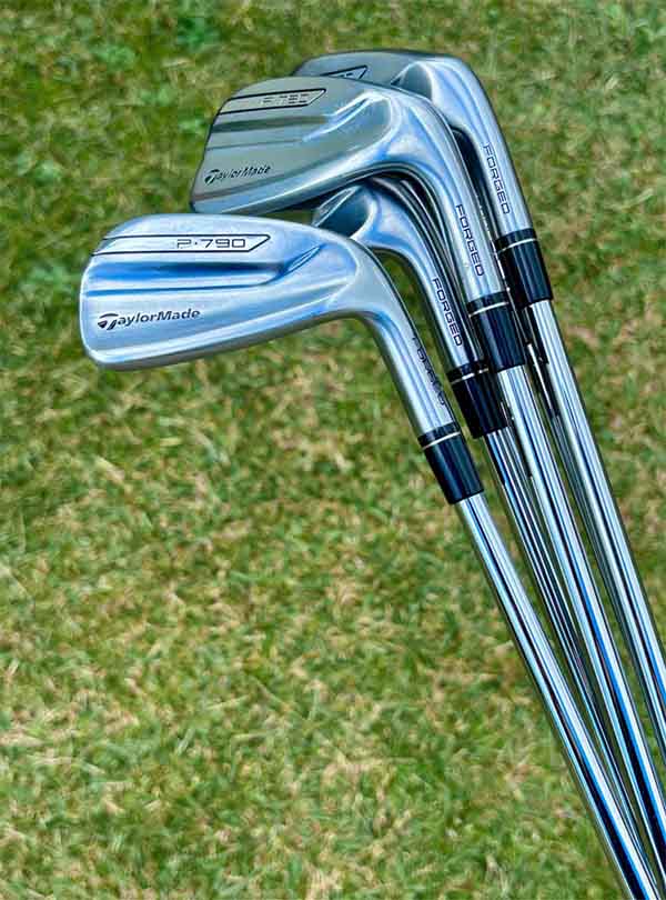 Set of golf iron clubs on a grassy background