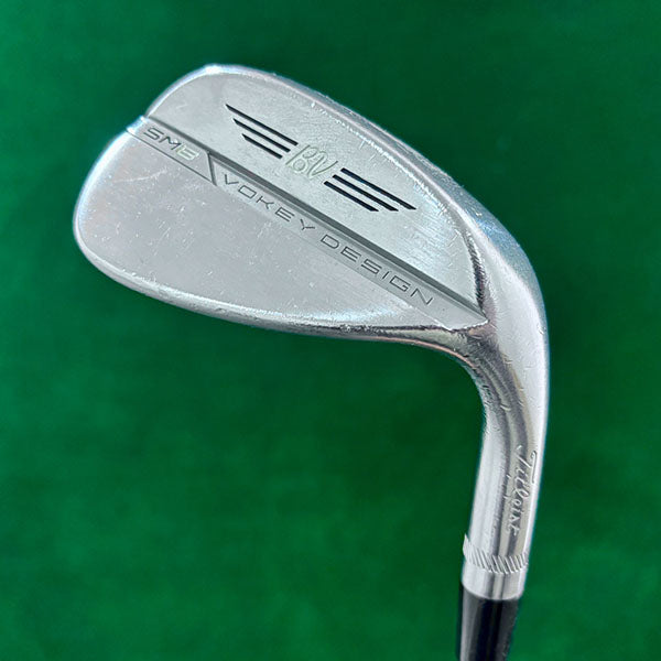 Golf club head with 'SM8 Vokey Design' branding on a green background