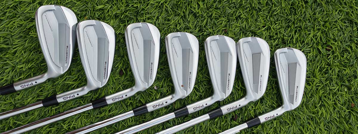 Set of golf clubs on a grass background